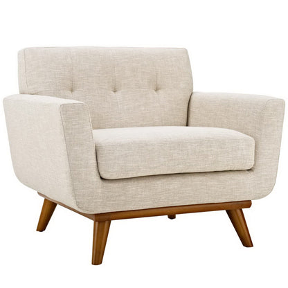 Beige fabric mid-century armchair with tufted back cushion and angled wooden legs.
