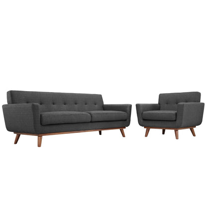 Dark gray mid-century modern sofa with tufted back and matching armchair on wooden legs.