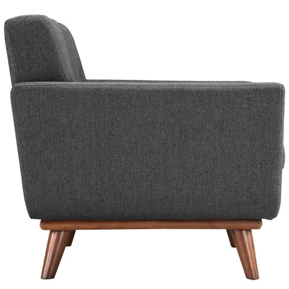 Side view of a dark gray textured fabric mid-century lounge chair with angled wooden legs.