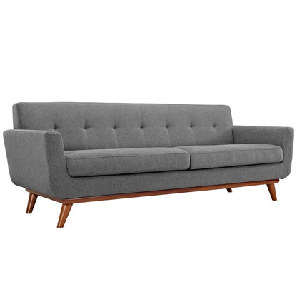 Gray fabric sofa with tufted back, two seat cushions, and angled wooden legs in mid-century style.
