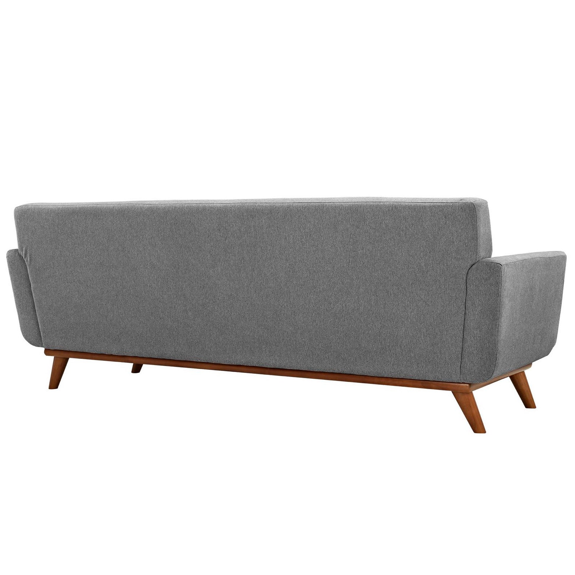 Back view of gray fabric sofa with wooden tapered legs and rounded arms, mid-century style.