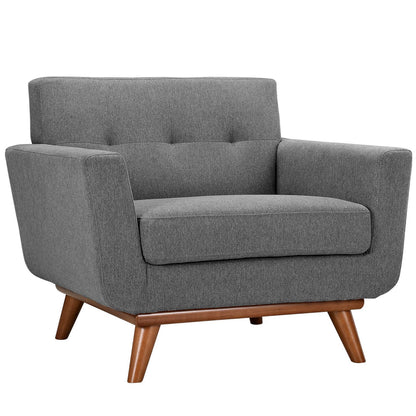Gray fabric mid-century armchair with tufted back, cushioned seat, square arms and wooden angled legs.