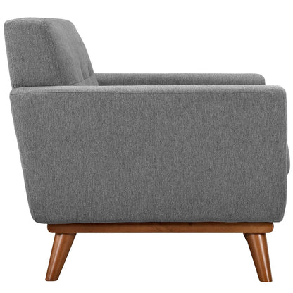Grey textured fabric armchair with wooden tapered legs, mid-century style, side view.