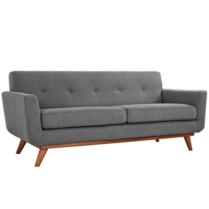 Mid-century modern gray fabric sofa with tufted back, two seat cushions and angled wooden legs.