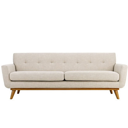 Beige tufted fabric sofa with two seat cushions, rounded arms, and angled wooden legs.