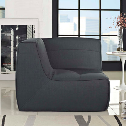 Charcoal gray fabric corner sofa with curved left-side arm and thick cushions in a modern living room.