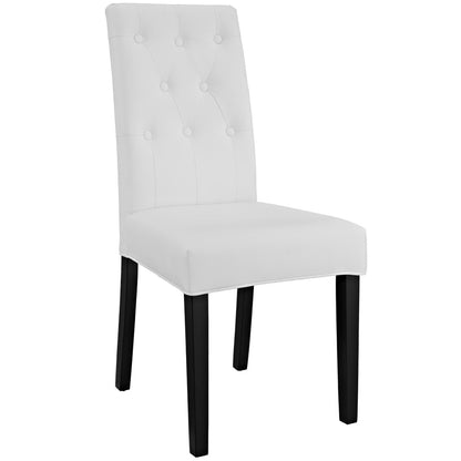 White tufted dining chair with tall back, buttoned upholstery and black wooden legs.