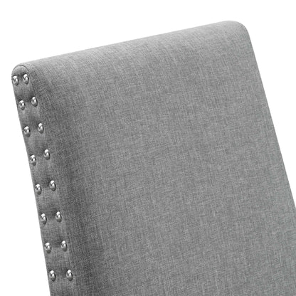 Gray fabric upholstered chair back with silver nailhead trim along the edge.