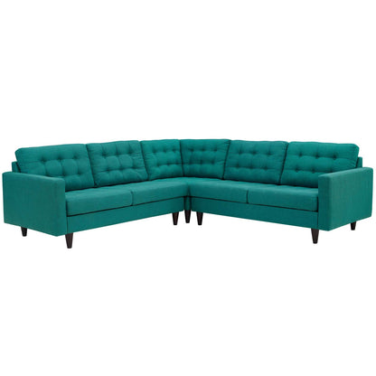 Teal velvet L-shaped sectional sofa with tufted back cushions and dark tapered wood legs.