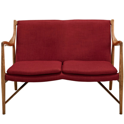 Red upholstered mid-century loveseat with wooden frame, curved arms, two seat cushions, and tapered legs.