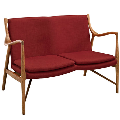 Mid-century red fabric loveseat with natural wood frame, curved arms and two cushioned seats.