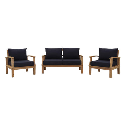 Teak outdoor patio set with navy cushions: left and right armchairs flanking a two-seat sofa.