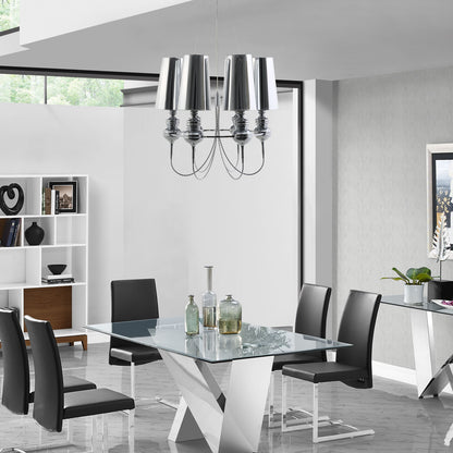 Stainless steel chandelier with a modern sculptural design hanging above a dining table in a bright dining room.