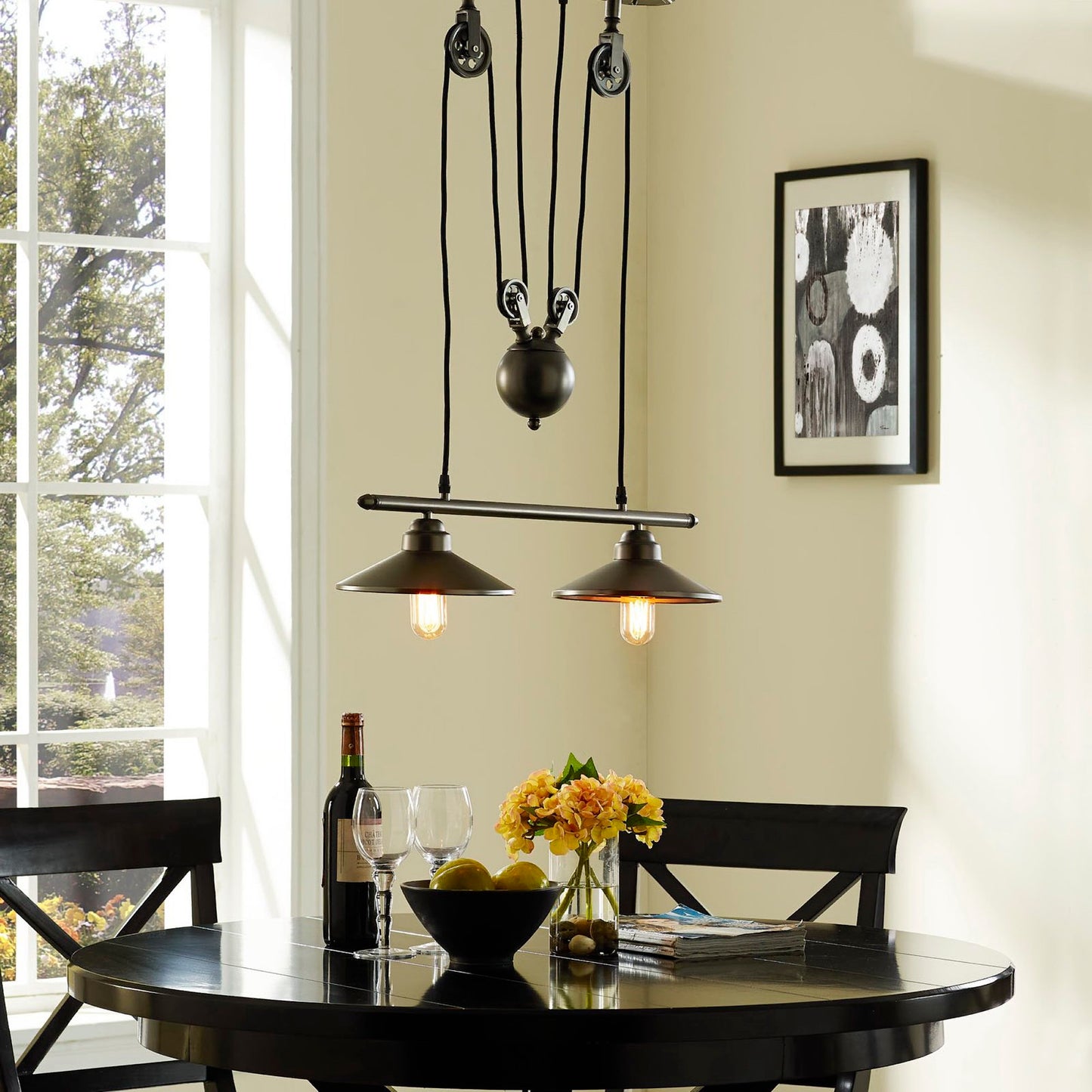 Two industrial pendant lights hanging from a silver ceiling fixture.