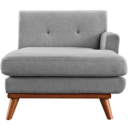 Gray fabric mid-century modern lounge chair with tufted back, armrest, thick seat cushion, and angled wooden legs.