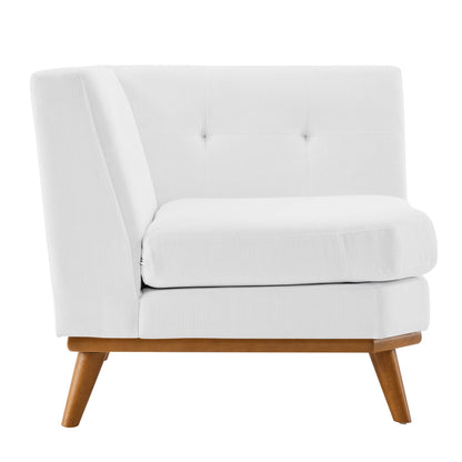 White fabric upholstered mid-century style corner chair with tufted back, thick cushioned seat, and angled wooden legs