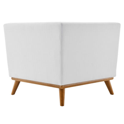 White fabric upholstered corner chair with light wood frame & angled legs, mid-century modern style.