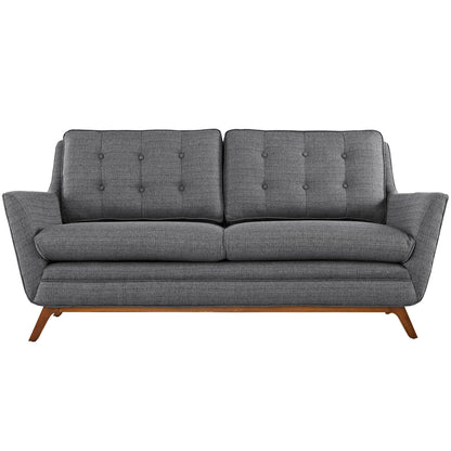 Gray fabric loveseat with button-tufted back cushions, mid-century modern style, angled wooden legs.