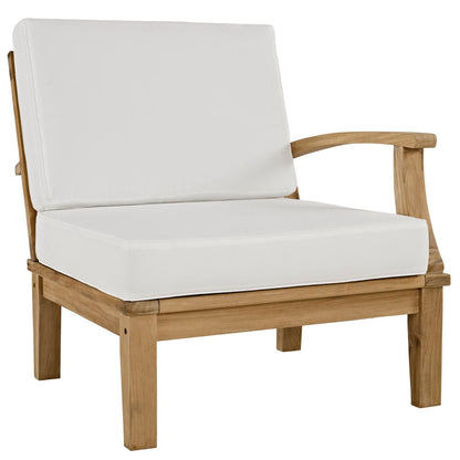 Natural wood outdoor armchair with white cushions, curved arms and sturdy square legs.