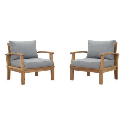 Natural teak outdoor armchairs with gray cushions, curved arms and square legs; set of two.