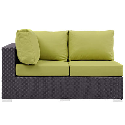 Dark brown wicker outdoor loveseat with lime-green cushions, two seat cushions, two back cushions and a round bolster for patio lounging.