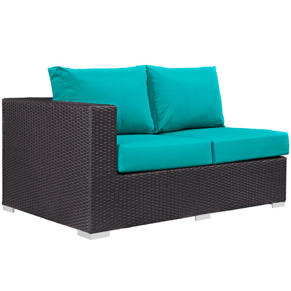 Teal outdoor wicker loveseat with dark brown woven frame & teal cushions.