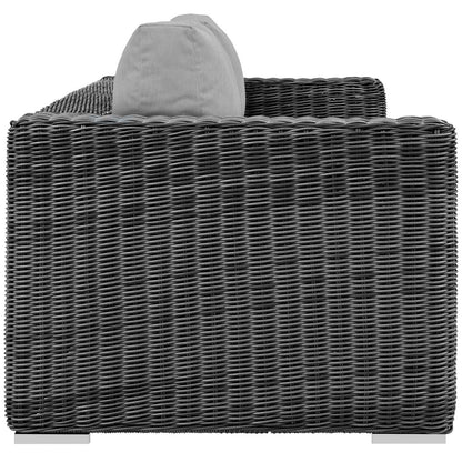 Dark gray woven rattan outdoor sofa with a light gray backrest cushion; modern patio seating.