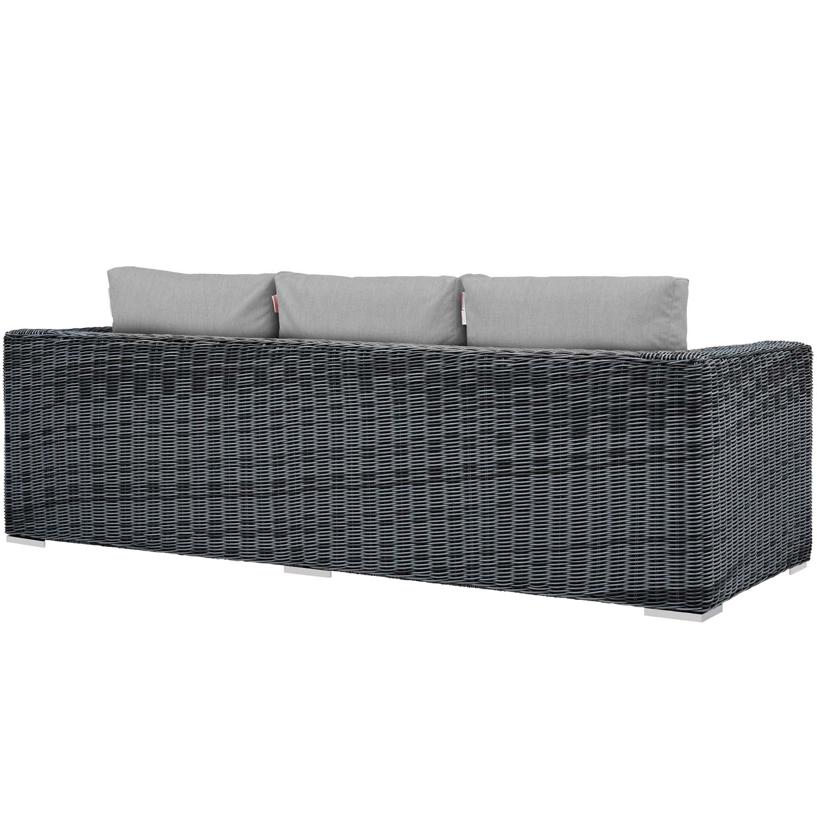Dark gray woven rattan outdoor sofa with light gray cushions, modern low-profile patio seating.