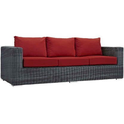 Gray woven outdoor rattan sofa with red cushions, three back cushions and three seat cushions.