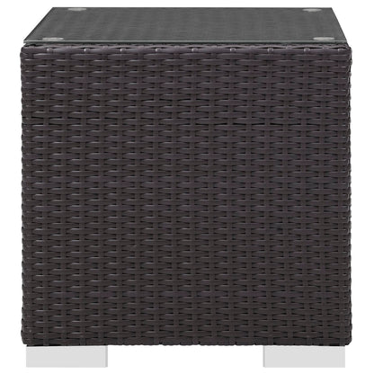 Dark brown woven rattan cube outdoor side table with glass top.