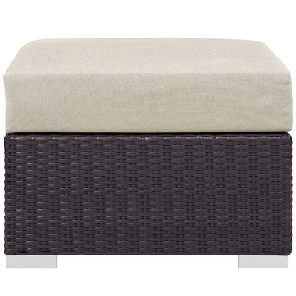 Dark brown woven wicker outdoor furniture piece with a beige cushioned top; part of a 3-piece outdoor patio set with a fire pit.