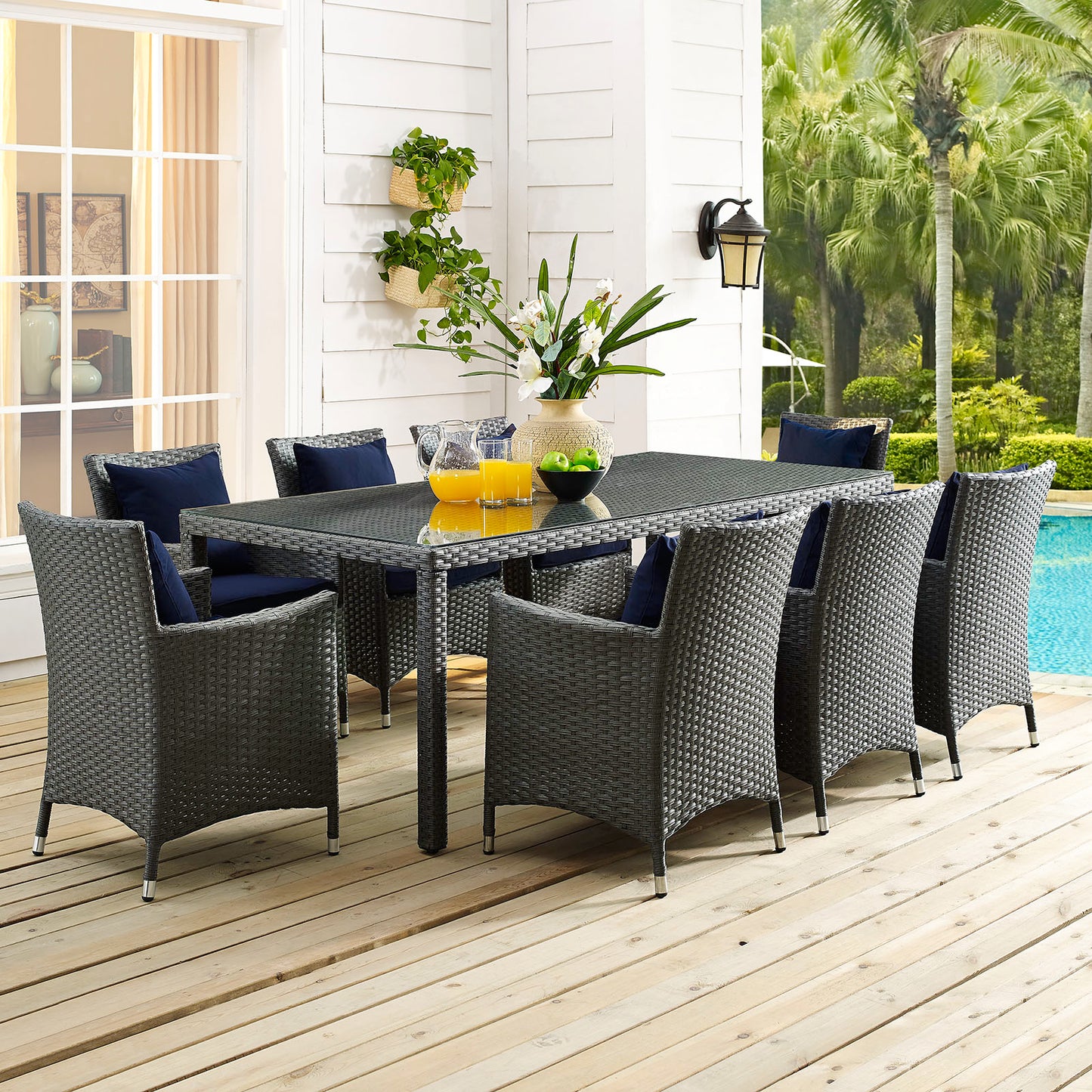 Chocolate brown 82" outdoor patio dining table on a wooden deck by a pool.