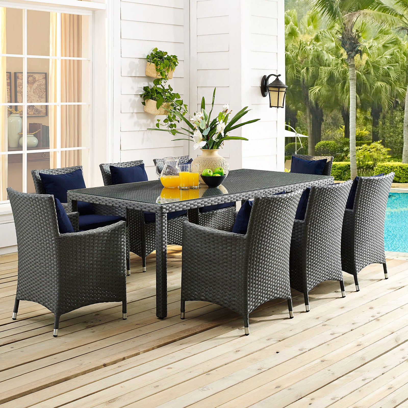 Chocolate brown 82" outdoor patio dining table on a wooden deck by a pool.