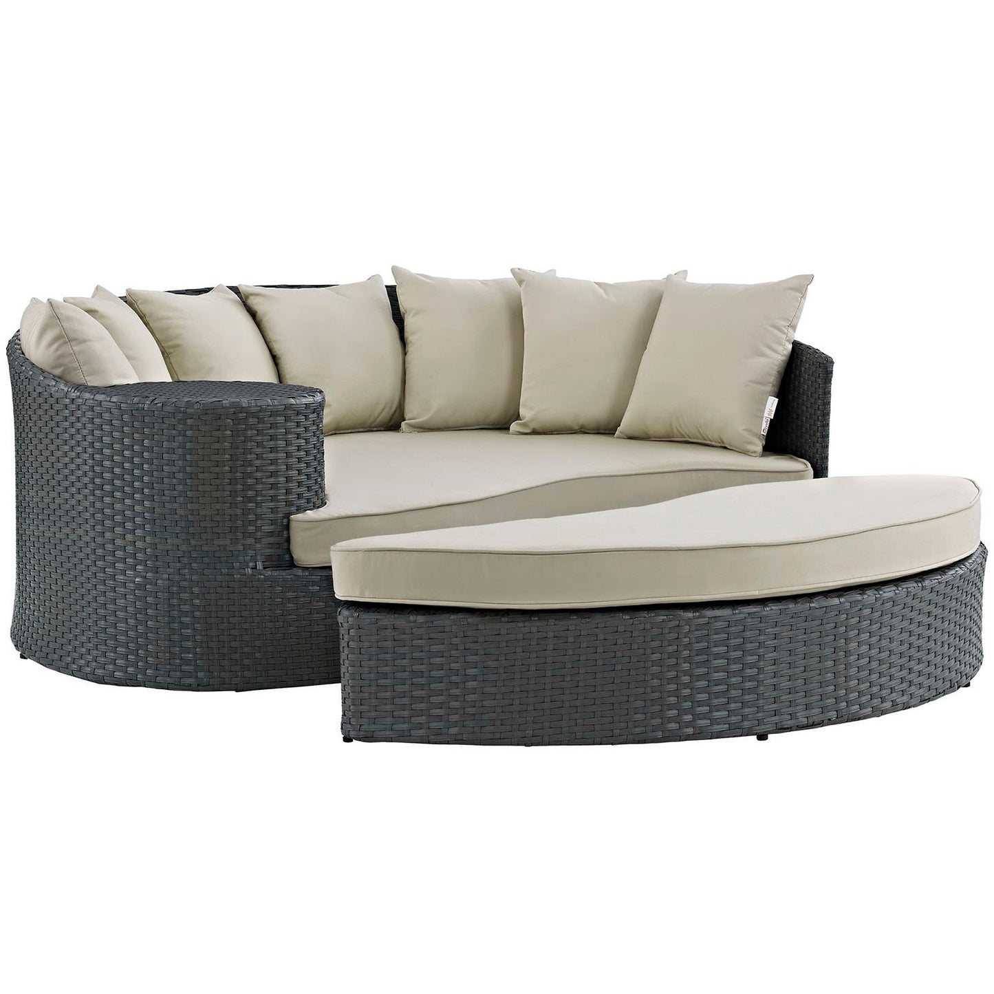 Dark gray woven rattan outdoor daybed with beige cushions and a curved ottoman.