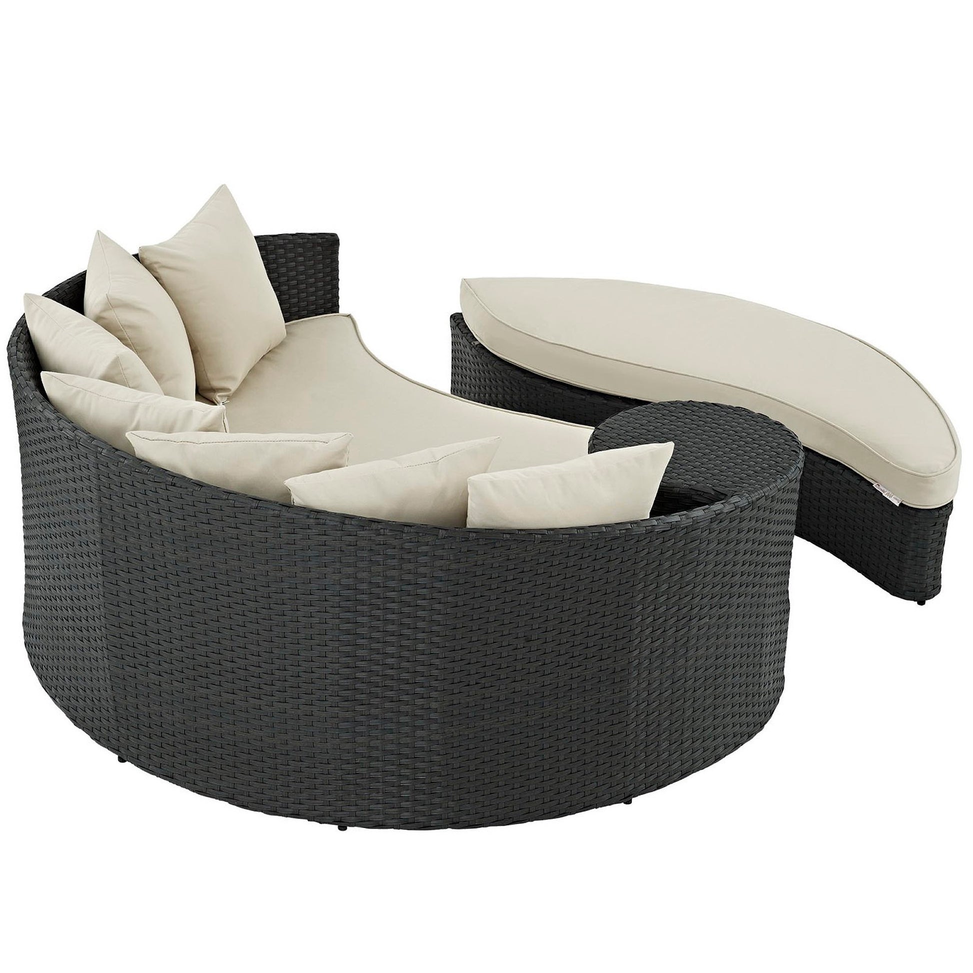 Dark brown wicker outdoor curved daybed with beige cushions and a matching curved ottoman.