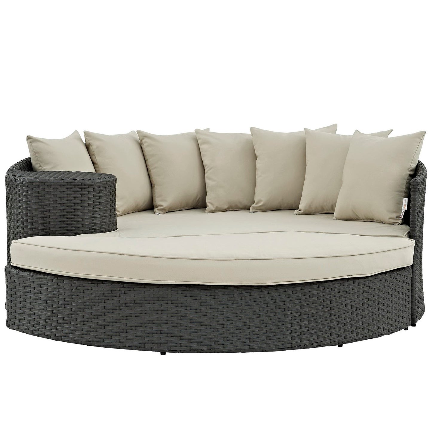 Round outdoor wicker daybed in dark charcoal with beige cushions and beige pillows.