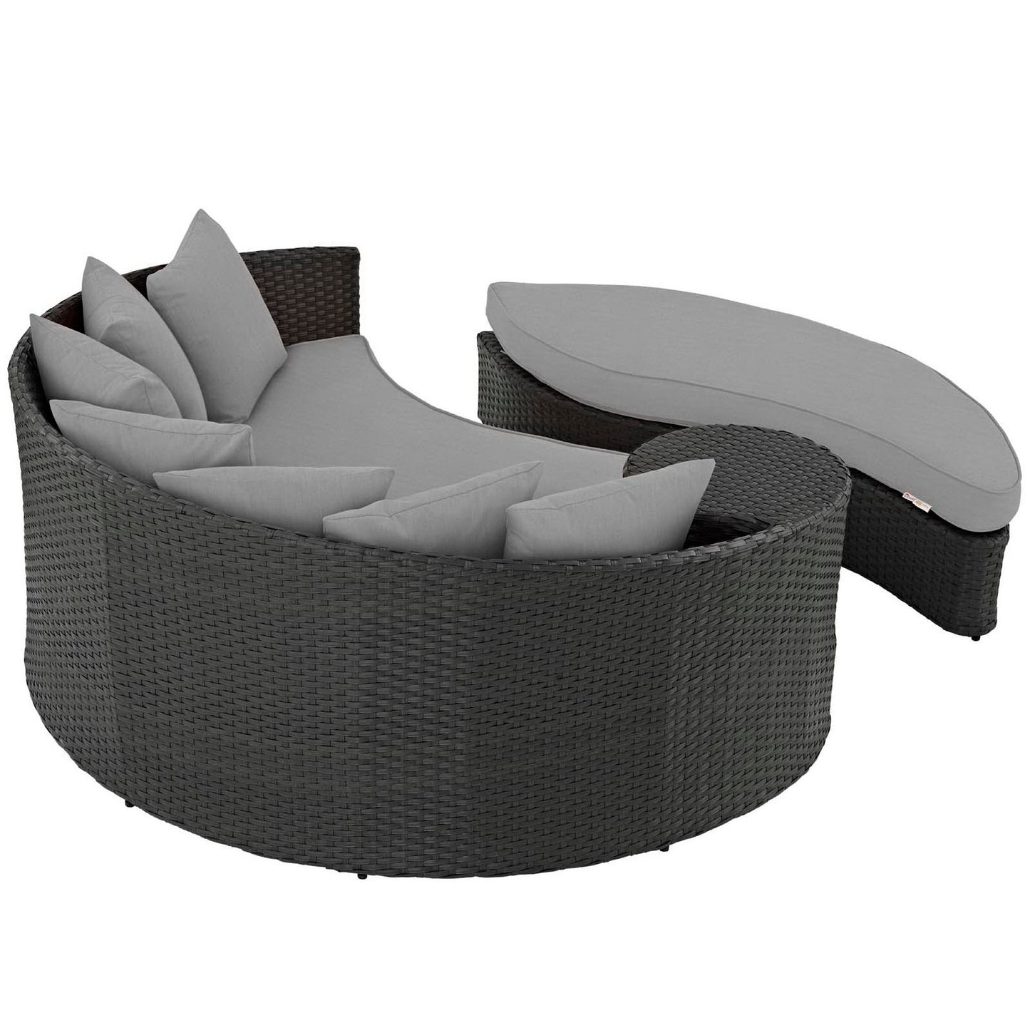 Charcoal gray circular wicker outdoor daybed with curved back and multiple gray cushions, plus matching oval ottoman.