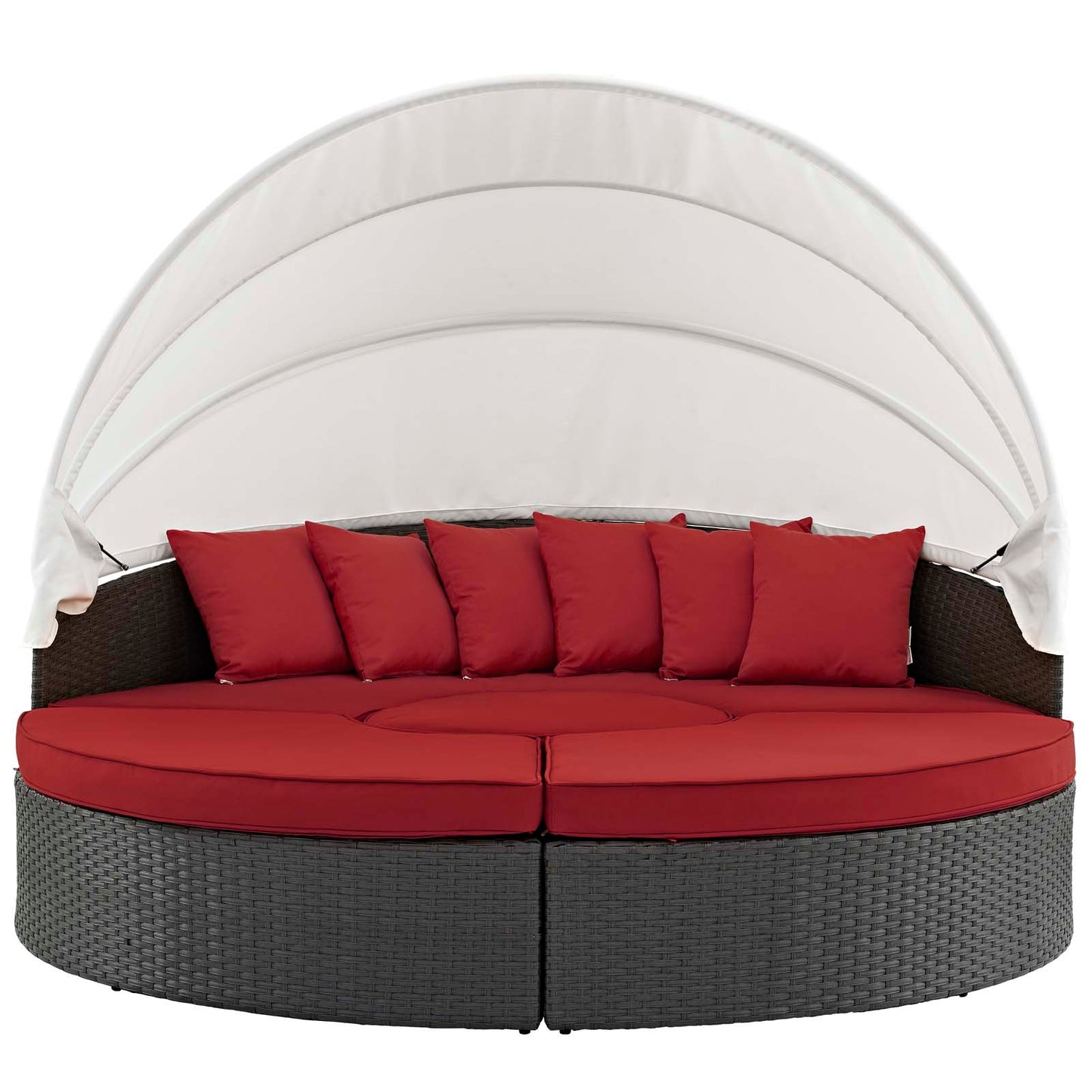 Round dark wicker outdoor daybed with red cushions and pillows under a white curved canopy.