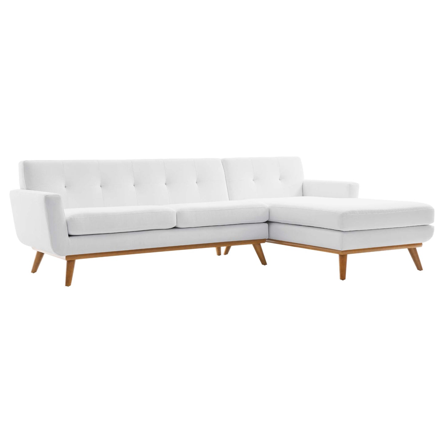 White fabric sectional sofa with tufted back, chaise lounge on the right, mid-century wooden legs.