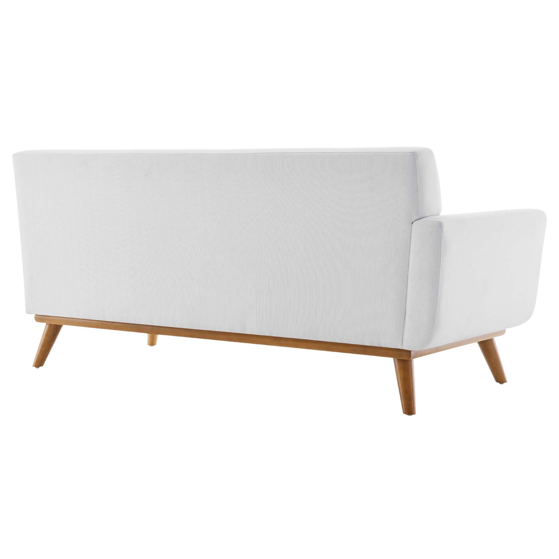 White fabric sectional sofa with right-facing configuration & wooden tapered legs in mid-century style; low back & armrest on one side.