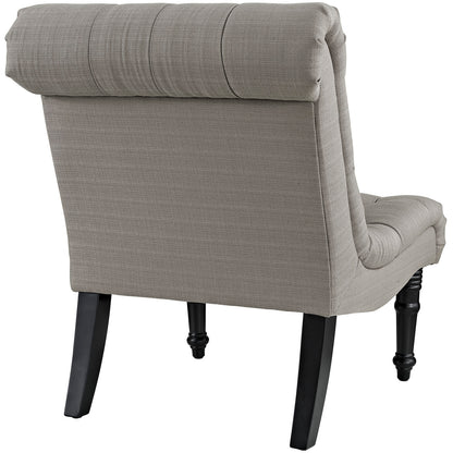 Taupe fabric accent armchair with rolled headrest cushion and dark wood turned front legs.