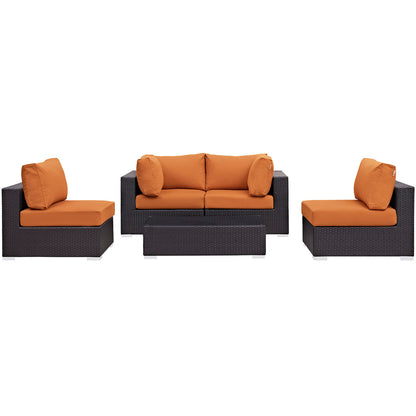 Dark brown wicker outdoor set with orange cushions: two chairs, a three-seat sofa, and a rectangular coffee table.