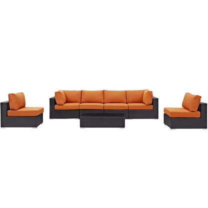 Outdoor black wicker seating set with orange cushions: a 3-seat sofa, & two single chairs, plus a rectangular coffee table.