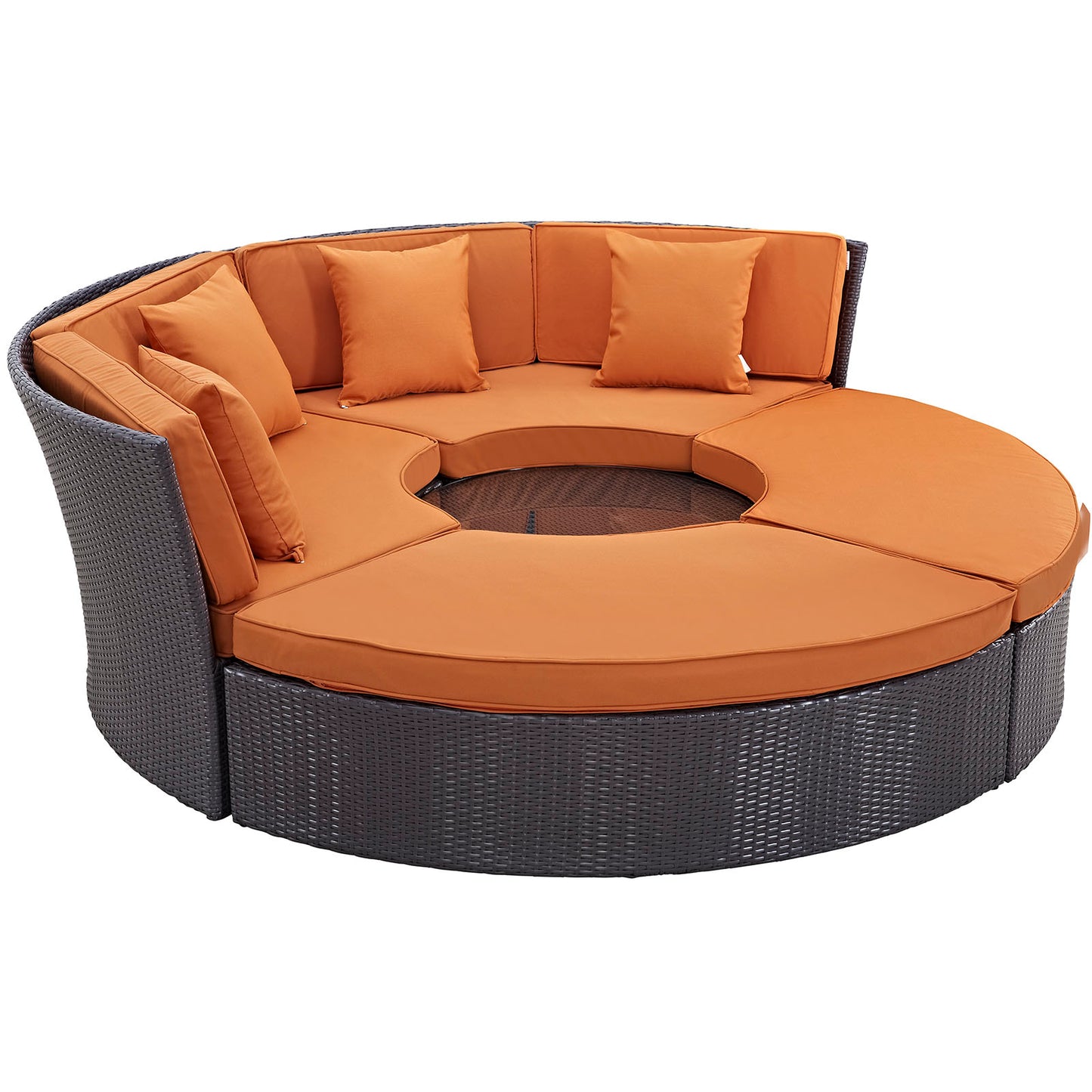 Round dark wicker outdoor daybed set with orange cushions and pillows, circular lounge around a central opening.