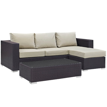 Dark brown wicker outdoor sectional with beige cushions & matching coffee table.
