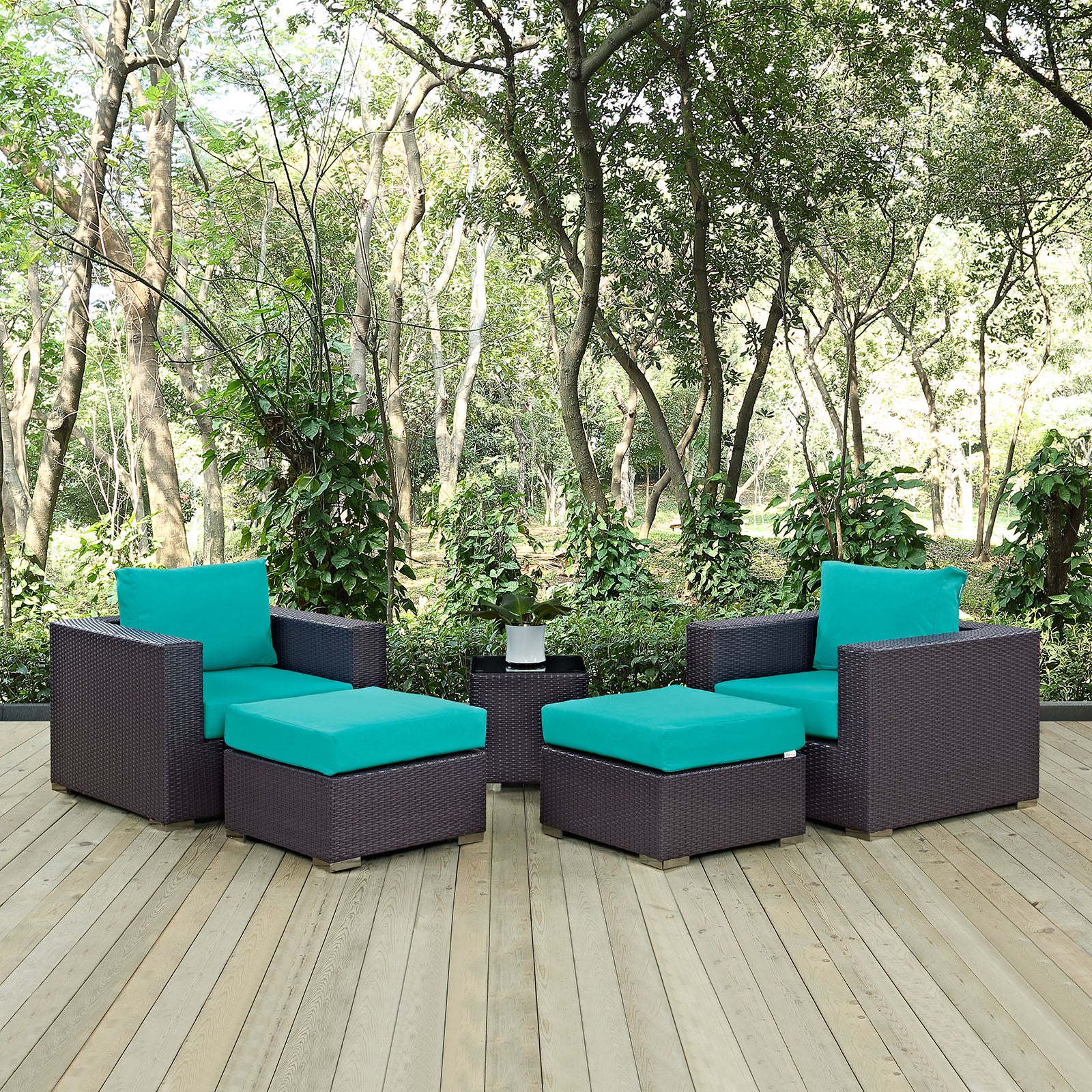 Dark brown wicker outdoor seating set with teal cushions; two armchairs, two ottomans, and a small side table.