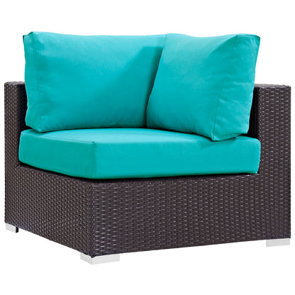 Dark espresso-brown wicker outdoor sectional set with turquoise cushions; square, boxy patio seating.