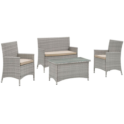 Light gray wicker outdoor patio set with beige cushions: two armchairs, a loveseat, and a glass-topped coffee table.