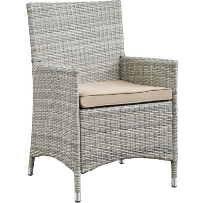 Light gray woven rattan outdoor armchairs with beige cushions; part of a 4-piece outdoor conversation set, featuring tall backs, curved arms and metal-tipped legs.
