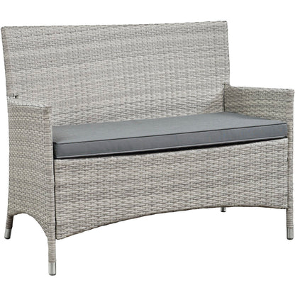 Gray wicker outdoor loveseat with a matching gray cushion, straight arms, and metal-tipped feet.